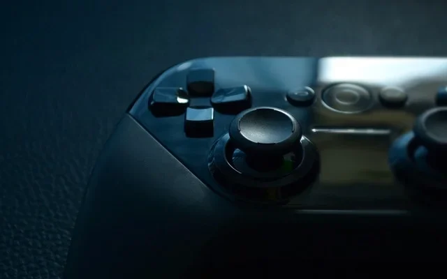 A focused codes etruesports view of a black and white video game controller, highlighting its unique features and style.