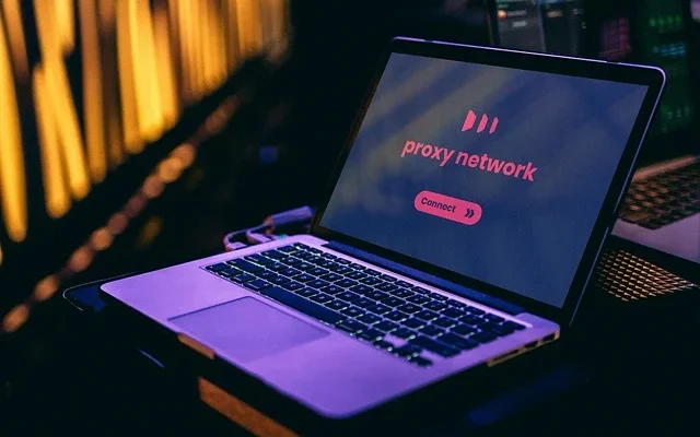 Mockup of a laptop displaying the Pray Network website, featuring the Proxyium logo prominently on the screen.