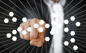 Businessman pointing at a network of interconnected hexagons, symbolizing collaboration and innovation at Fapelli.