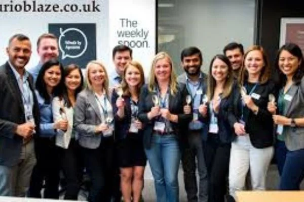 Team members smiling in kitchen workspace – Meet Team TheWeeklySpooncom